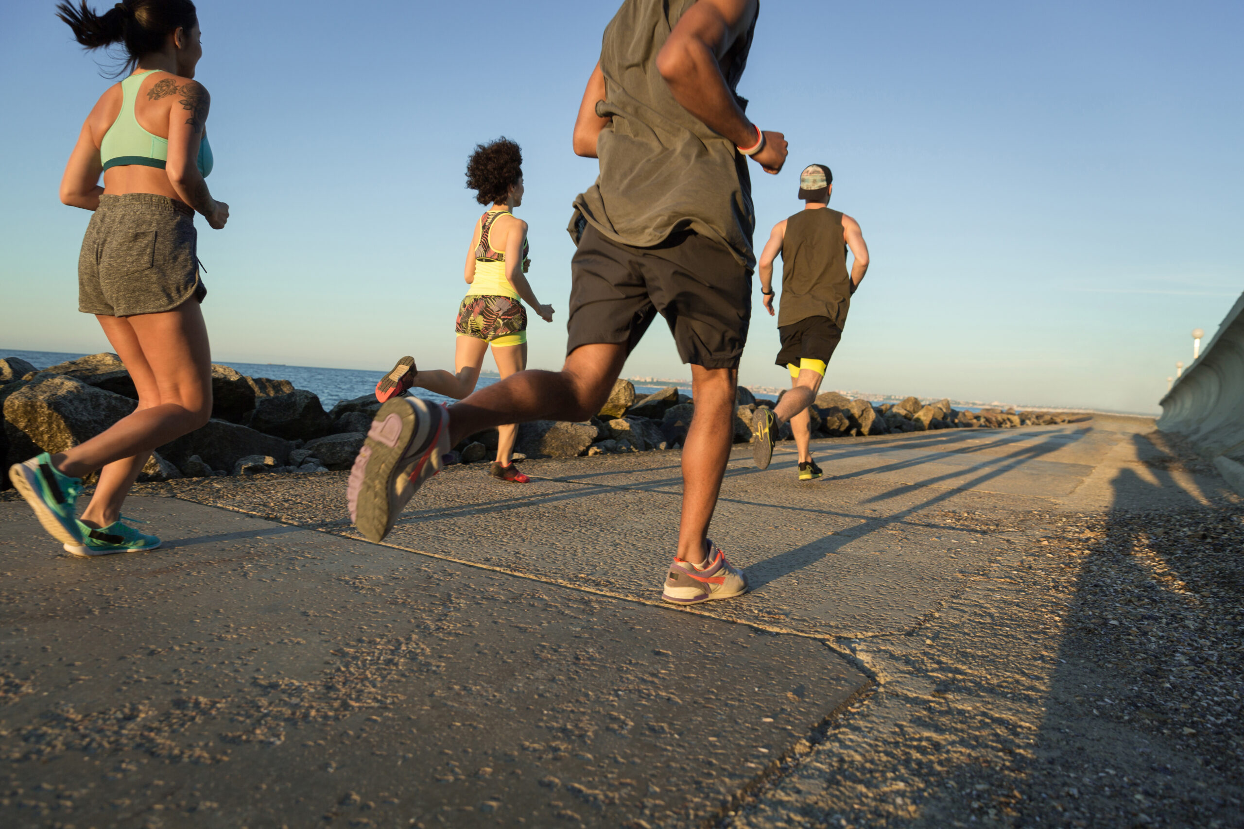 back view of a group of young sporty friends jogging